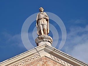 Traditional statue as a decoration on the roof of a classic house in Leiria