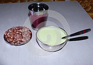 Traditional steamed milk pudding in a silver bowl with peanuts and water