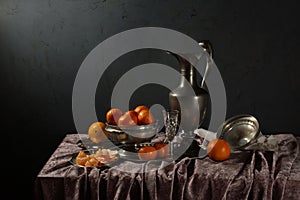 Traditional still life with tin old jug and tangerines