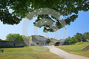 Traditional stone buildings & open grass land inside the citadel of Blaye, Gironde, Nouvelle- Aquitaine, France. photo