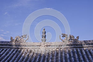 Traditional stone dragon decoration on the roof in the old town of Dukezong, Shangri La, Yunnan, China