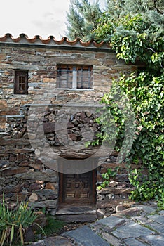 Traditional stone house with climbing plant. Patones de Arriba, Madrid photo