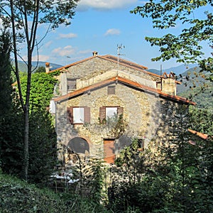 Traditional stone mountain house in green forest at Prats de Mollo la Preste, Pyrenees-Orientales in southern France photo