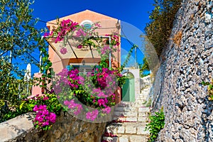 Traditional street with greek houses with flowers in Assos, Kefalonia island. Traditional colorful greek houses in Assos village.