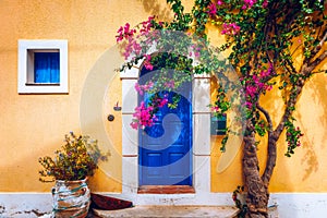 Traditional street with greek houses with flowers in Assos, Kefalonia island. Traditional colorful greek houses in Assos village.
