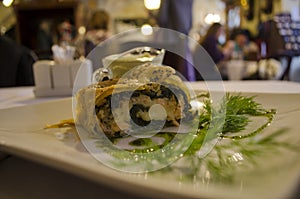 Traditional strudel of salmon with pesto sauce