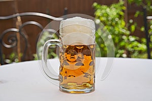 Traditional style half litre mug full of cold pilsner beer.