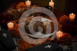 Traditional sugary bread of the dead, celebrating Dia de Muertos with cempasuchilt flowers and cardboard coffins