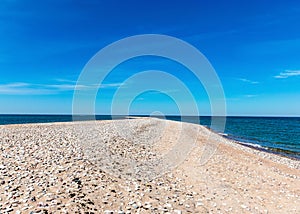 Traditional summer landscape with sandy and pebbly promontory, blue sea and sky, Harilaid Nature Reserve, Estonia, Baltic Sea