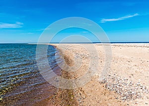 Traditional summer landscape with sandy and pebbly promontory, blue sea and sky, Harilaid Nature Reserve, Estonia, Baltic Sea