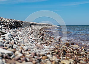Traditional summer landscape with sandy and pebbly promontory, blue sea and sky, Harilaid Nature Reserve, Estonia, Baltic Sea