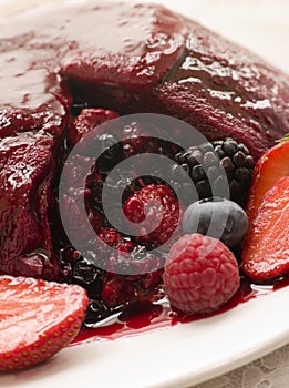 Traditional Summer Pudding with a scoop out