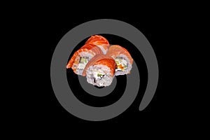 Traditional sushi - Philadelphia with salmon, avacado and cheese on black background.