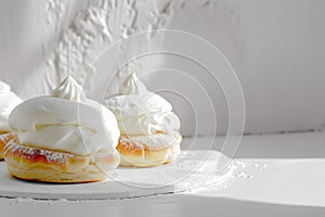 Traditional Swedish Semla Pastries with Whipped Cream on White Background.
