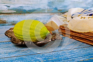 Traditional symbols Jewish festival of Sukkot Etrog, lulav, hadas, arava praying book kippah Tallit