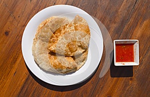 Traditional Tatar pastry Chiburekki aka Cig borek on wooden table, Eskisehir, Turkey