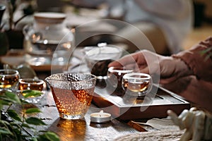 Traditional tea ceremony - pouring chinese oolong in glass cup
