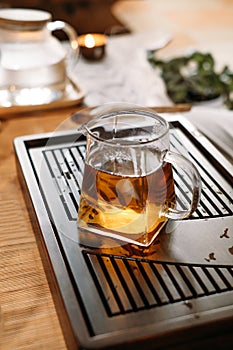 Traditional tea ceremony - pouring chinese oolong in glass cup