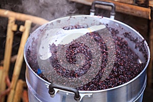 Traditional Thai Black Steamed Sticky Rice in Hot Steamer, delicious wholegrain alternative to white rice, is purplish black in