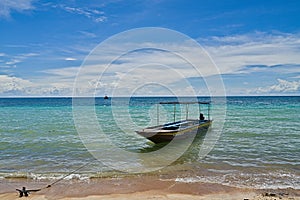 Traditional Thai boat tied on the shore of Koh Tao