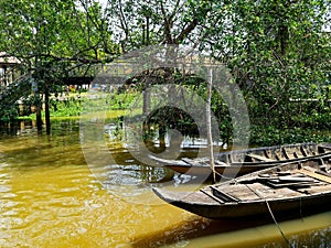 Traditional Thai boats are floating on the river.