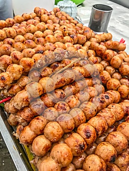 Traditional Thai charcoal roasted Isaan Sausage, on banana leaf background. Asian, Thai styled street food appetizer