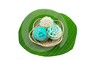 Traditional Thai dessert flower shape stuff with crush soybean and taro Thai name kanom Chor phaka in bamboo basket on green