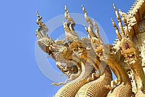 Traditional thai dragon statue against blue sky