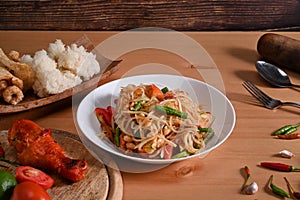 Traditional Thai food papaya salad  in white plate on wooden background.