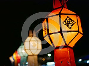 Traditional Thai Lanna hanging paper lanterns being used to decorate the street during the night