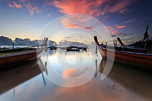 Traditional Thai longtail boat at sunrise beach in Phuket