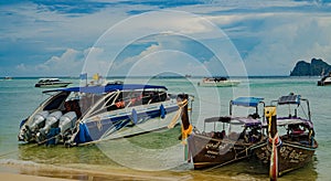 Traditional Thai Longtail boats and new speed boats on Phi Phi island, Thailand