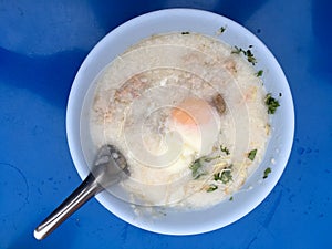 Traditional thai porridge rice gruel in white bowl, congee. In the street night market.