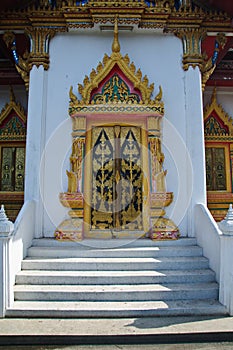 Traditional Thai style door carving and painting art at the temp