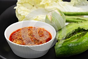 Traditional Thai-style food with fresh vegetables with spicy chili sauce