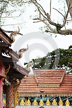 Traditional Thai style golden Naga on Art of Roof sculpture on ancient buddhism temple