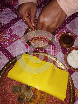 Traditional Thali with dhan and Indian men hand photo