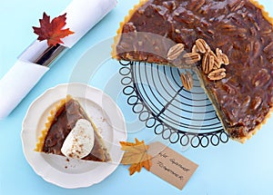 Traditional Thanksgiving Pecan Pie on Pale Blue Wood.