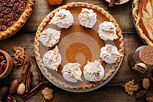 Traditional Thanksgiving pumpkin pie topped with whipped cream