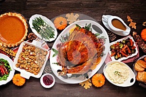 Traditional Thanksgiving turkey dinner overhead table scene on dark wood