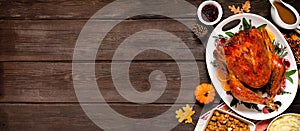 Traditional Thanksgiving turkey dinner. Overhead side border on a dark wood banner background.