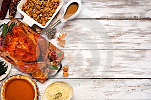 Traditional Thanksgiving turkey dinner. Top view side border on a rustic white wood background.