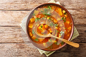 Traditional thick sweet potato soup with lentils close up in a bowl on the table. Horizontal top view