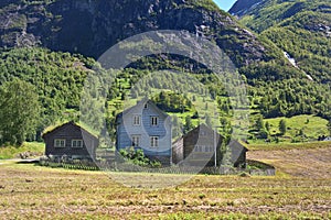 Traditional timber farm buildings below the mountain