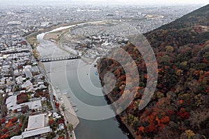 Traditional touris travel boat on the river in Kyoto city with autumn season background photo