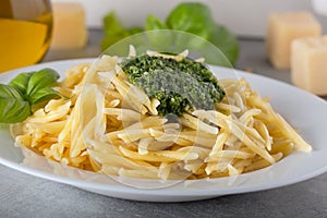 Traditional trofie pasta with pesto sauce on white plate