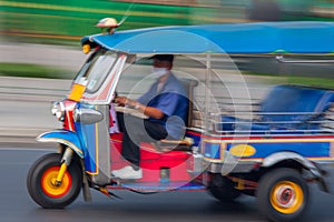 Traditional tuk-tuk from Bangkok, Thailand, in motion blur.