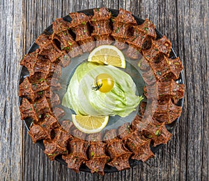 Traditional Turkish appetizer Cigkofte with lavash, ingredients are raw, meat bulgur ,onion, tomato paste, chili pepper and salt.