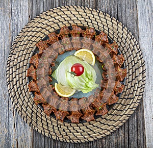 Traditional Turkish appetizer Cigkofte with lavash, ingredients are raw, meat bulgur ,onion, tomato paste, chili pepper and salt.