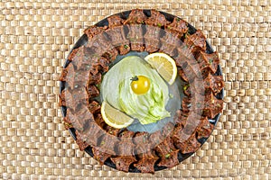 Traditional Turkish appetizer Cigkofte with lavash, ingredients are raw, meat bulgur ,onion, tomato paste, chili pepper and salt.